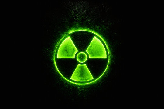 A glowing neon green radiation symbol is displayed against a black background.