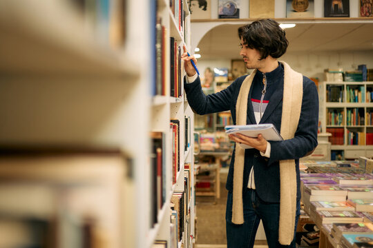 Young man browsing books in a bookstore