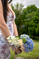 closeup outdoor profile portrait woman dress holding bouquet of flowers no face © Lisa Kim