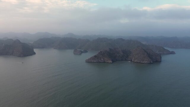 Breathtaking aerial footage flying over the iconic limestone cliffs and islands of halong bay, vietnam