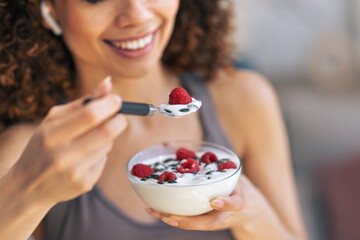 Naklejka premium Pretty woman eating healthy yogurt bowl at home