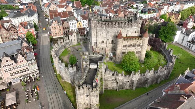 Aerial drone view of Ghent old town in Belgium, with the towers of St. Nicholas and St. Michael's Churches and Castle of the Counts next to river Lys. Architecture and landmarks of the medieval city.