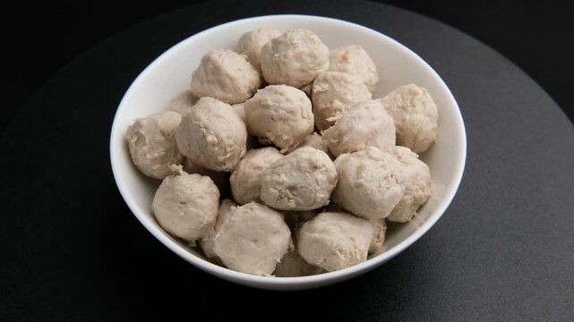 Pork tendon meatballs in white bowl.(Thai Pork Tendon Balls)