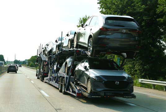 Pennsylvania, U.S.A - Jul 17, 2026 - Car carrier truck transporting multiple new Mazda vehicles on the highway