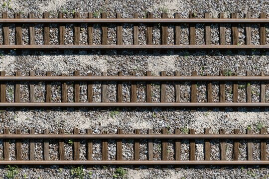 Parallel railroad tracks laid across a gravel bed, seen from above
