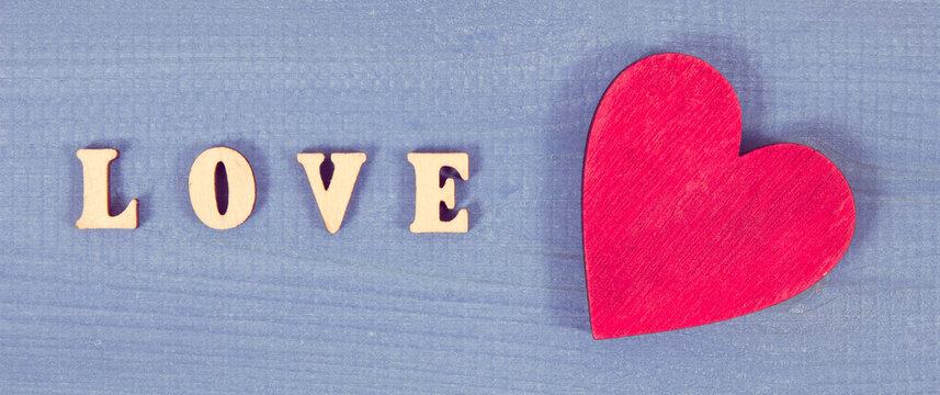 Red heart with word love as symbol of Valentines Day