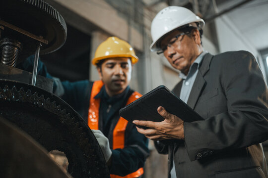 kpi productivity efficiency business Factory manager reviewing production KPI and equipment performance with a tablet highlighting quality control productivity engineering and manufacturing efficiency