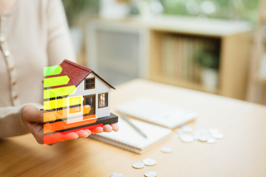 Home energy efficiency concept with a house model and energy rating, highlighting renewable energy savings, cost analysis, and sustainable investment.