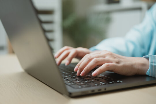 Hands typing on a laptop in a modern workspace, representing freelance work, digital business, AI productivity, and online communication.
