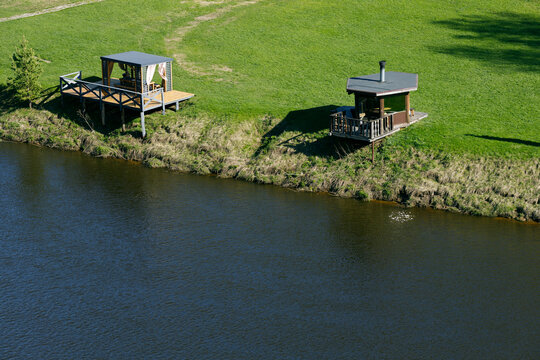 Two Riverside Retreat Buildings on a Sunny Summer Day