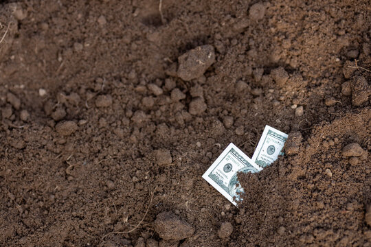 Two Hundred-Dollar Bills Buried in the Ground Economic Crisis