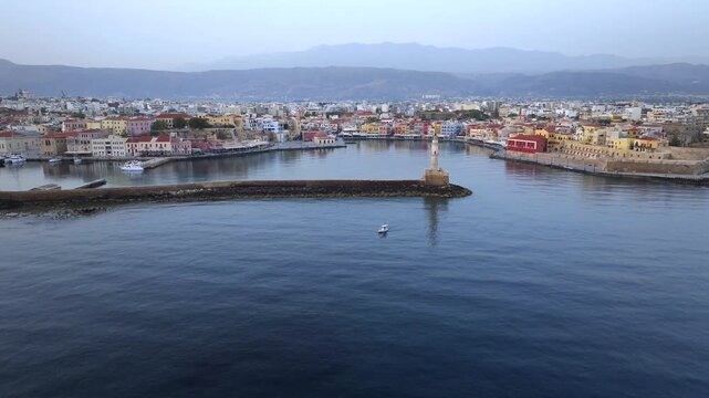  View of Chania with the amazing lighthouse, mosque, venetian shipyards, Crete, Greece.Waves crashing on lighthouse, Beautiful Greece and best scenic places - panorama