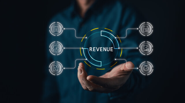 Close up of businessman holding virtual revenue circle graphic with digital finance icon interface for financial management, profit maximization, and business income analysis.