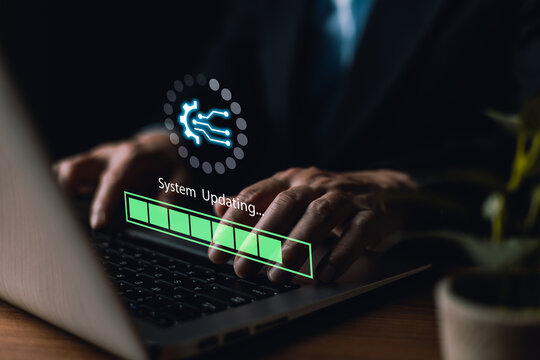 Businessman hands typing on laptop keyboard to update system with virtual progress bar graphic for software upgrade, data install, tech installation, and cyber security improvement in dark studio.