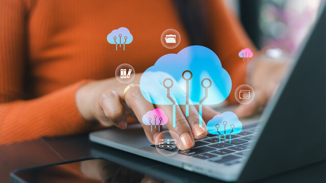 Person using laptop with cloud computing icons representing data storage and internet connectivity