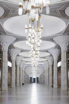 Mustaqillik Maydoni metro station interior with ornate chandeliers and marble columns in Tashkent, Uzbekistan. Symmetrical underground hall showcasing Soviet-era architectural grandeur.