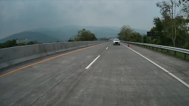 Rear Dashcam Drive on Malang&ndash;Surabaya Toll Road with Scenic Mountain and Green Hills, East Java, Indonesia