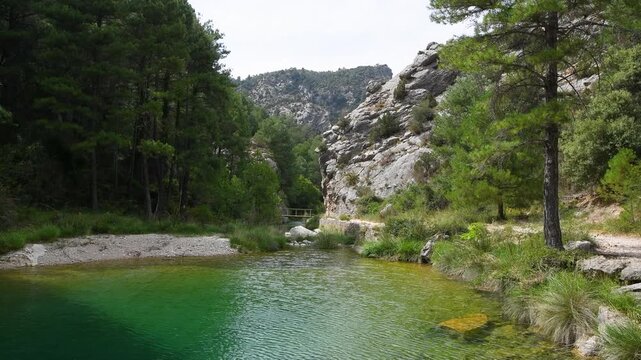 Crystal Clear River and Wooden Footbridges at El Parrizal de Beceite Nature Reserve