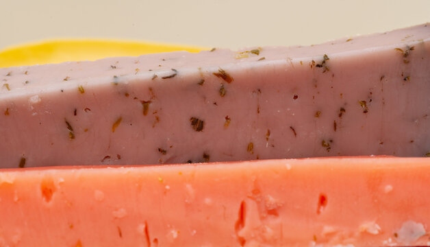 different types of gouda: plain yellow cheese and green cheese with pesto, spices and nuts. Cheese plate