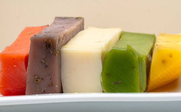 different types of gouda: plain yellow cheese and green cheese with pesto, spices and nuts. Cheese plate