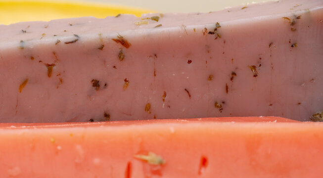 different types of gouda: plain yellow cheese and green cheese with pesto, spices and nuts. Cheese plate