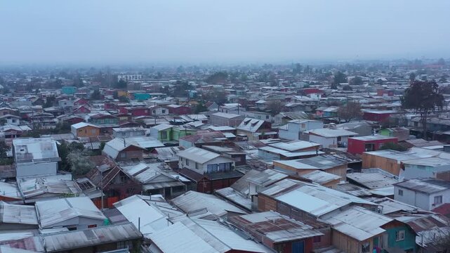 Aerial view of crowded houses in a suburban residential neighborhood in Santiago de Chile on a foggy day