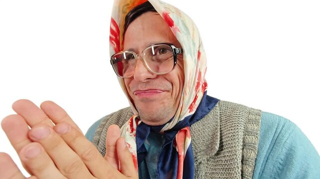 Funny old grandmother rubbing hands together with a sly happy smile on face