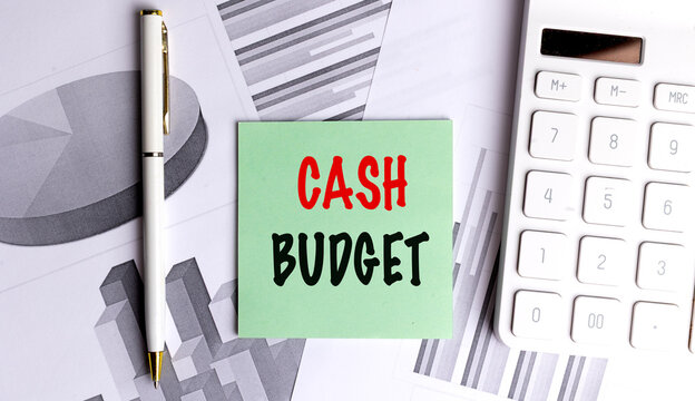 Cash budget concept with sticky note calculator financial charts and pen representing business budgeting cash planning