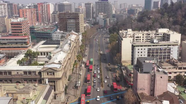 Aerial view of a unique triangular red residential building at a street intersection in Santiago de Chile