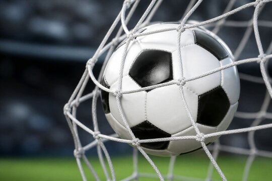 Soccer ball hitting goal net in stadium closeup view