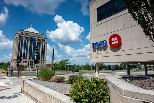 Wausau, WI, USA - Jul 11, 2026: Dudley Tower rising into a blue sky behind a corporate BMO bank branch building in downtown. Editorial Use Only.