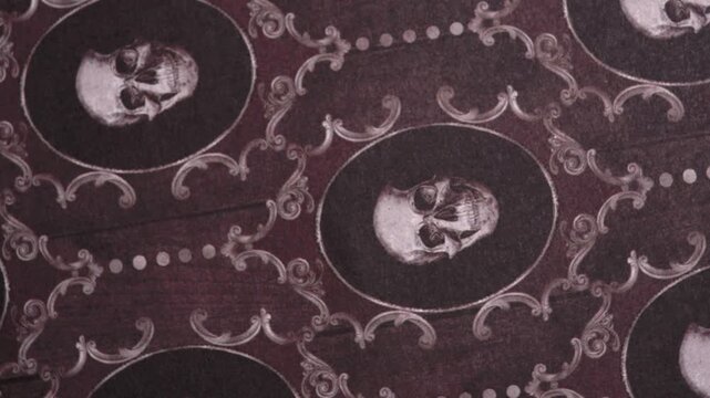 Rotating Close Up Shot of Gothic Oval Skull Damask Patterned Paper, halloween rotating background
