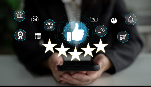 Professional hand holding smartphone with rating stars and review icons, digital technology concept for customer feedback and business evaluation. Sentient.