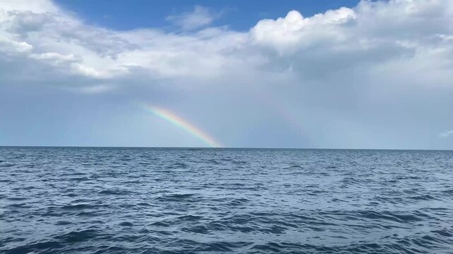 Beautiful Rainbow Over Wavy Ocean Surface