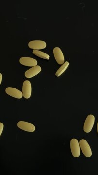Hand Gathering Yellow Tablets Top Down View