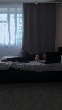 Overworked Female Closing Laptop in Dark Room
