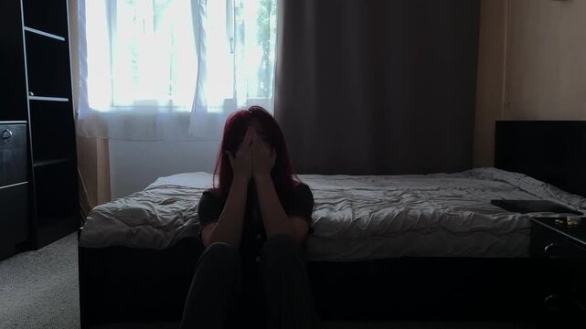 Depressed Young Woman Crying on Bedroom Floor