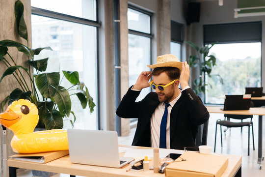 Businessman dreaming of summer vacation at office desk
