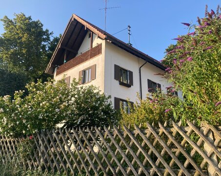 Traditional bavarian residential house with wooden balcony and fence in Seefeld Germany