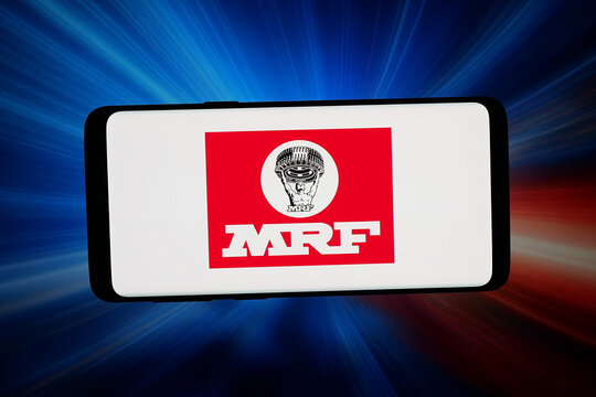 Stuttgart, Germany - 07-15-2026: In this photo illustration, the logo of Indian tyre manufacturing company MRF Tyres is displayed on a smartphone in front of abstract background on computer screen.