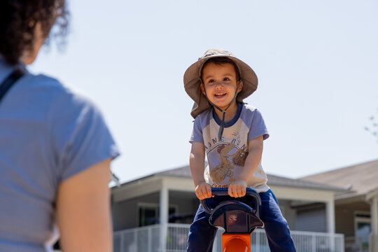 Happy Young Boy Playing on Seesaw at Park With Parent in Chilliwack British Columbia