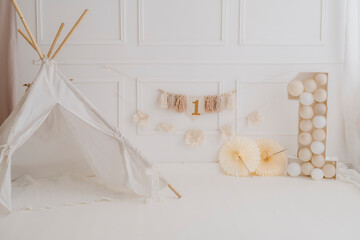 Minimal Boho First Birthday Backdrop with Teepee Tent and Number One Decoration © antonella