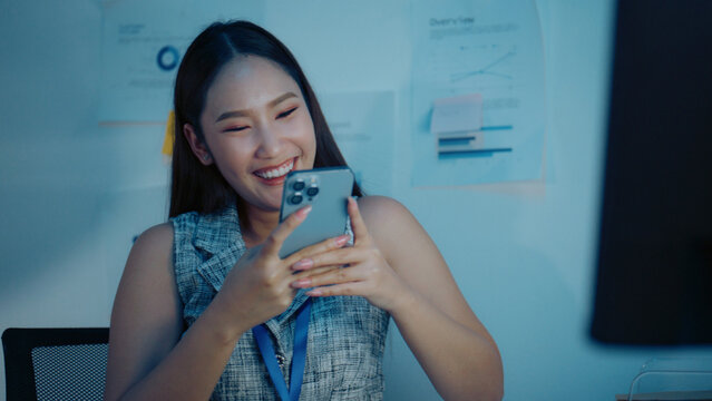 Overtime, worker, and smart phone scene featuring social network and social in a contemporary setting, social media, chatting, relaxed, relaxing, smartphone, woman, contact, office.