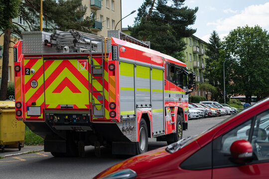 Fire truck driving in a parking lot.
