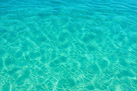 Clear turquoise water rippling with sunlight reflections