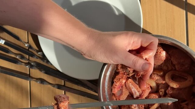 Hand stirring marinated meat in a metal bowl on a kitchen counter, warm sunlight creates a rustic home cooking mood, ideal for recipe prep and food blog use
