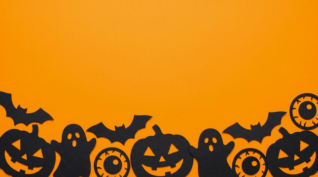 Halloween orange background featuring jack o lantern pumpkins, eyeballs, ghosts and bats paper cut out bottom border with spooky copy space for party invitation, banner and autumn design