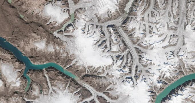 View from above on glaciers flowing into fjords. Camera is moving forward and left. Animation based on image by NASA