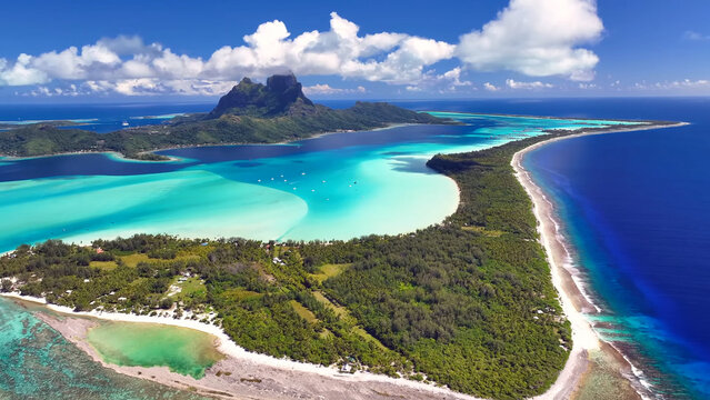 Luxury resort photo of French Polynesia tropical paradise island Bora Bora in Pacific Ocean. Sandy beach, palm trees, coral reef, azure ocean, sky 
with clouds on horizon. Drone aerial view.