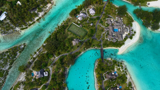 Luxury resort photo of French Polynesia tropical paradise island Bora Bora in Pacific Ocean. Beautiful photography with sandy beach, palm trees, coral reef, azure ocean. Drone aerial view.